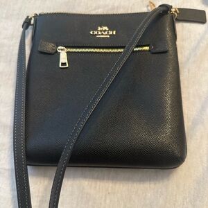 Cute, black Coach crossbody purse.
